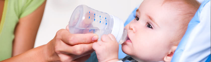 Baby Drinking Rainwater from Bottle